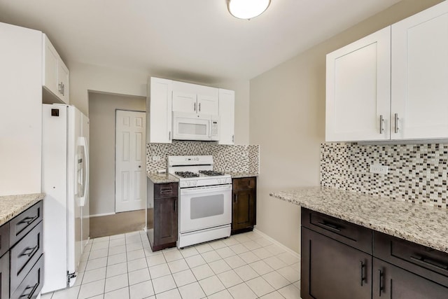 1608 Pennsbury Ct Unit A2, Wheeling, IL 60090 - kitchen featuring white appliances, white cabinets, tasteful backsplash, and baseboards