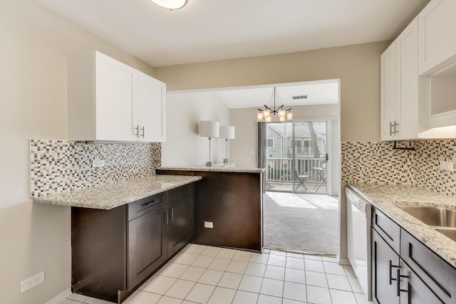 1608 Pennsbury Ct Unit A2, Wheeling, IL 60090 - kitchen featuring white cabinets, light stone counters, a chandelier, and dishwasher