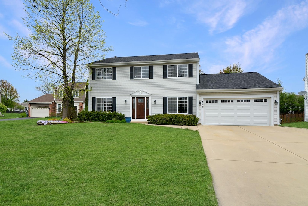 503 Yardley Dr, Carol Stream, IL 60188 - colonial-style house with a garage, concrete driveway, and a front lawn
