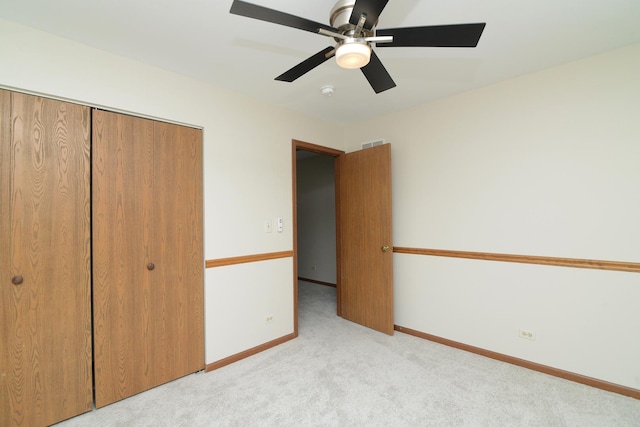 unfurnished bedroom featuring a closet, visible vents, baseboards, a ceiling fan, and carpet