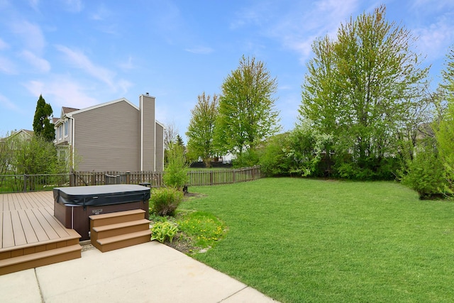 view of yard featuring a hot tub, a deck, a fenced backyard, and a patio area