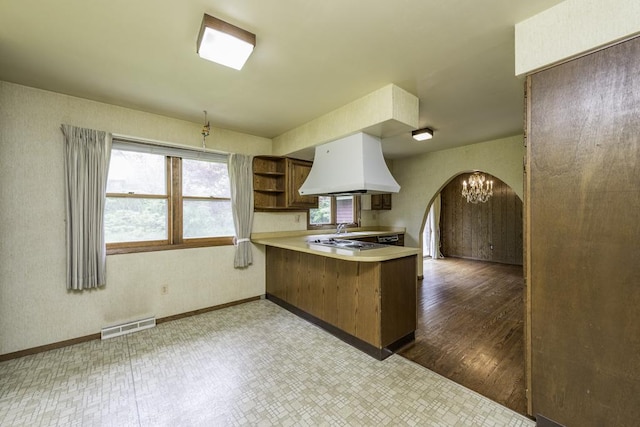 301 Garnett Ave, Winthrop Harbor, IL 60096 - kitchen featuring custom range hood, a peninsula, arched walkways, open shelves, and tile patterned floors