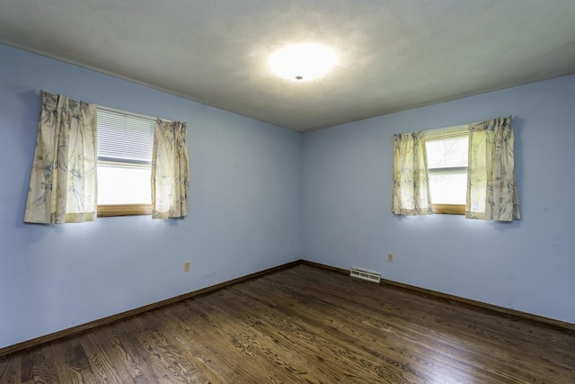 301 Garnett Ave, Winthrop Harbor, IL 60096 - unfurnished room with dark wood-style floors and baseboards