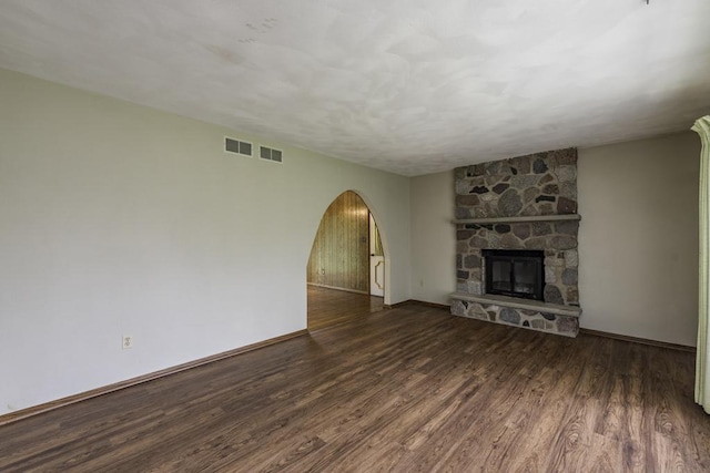 301 Garnett Ave, Winthrop Harbor, IL 60096 - unfurnished living room with arched walkways, wood finished floors, baseboards, and a fireplace