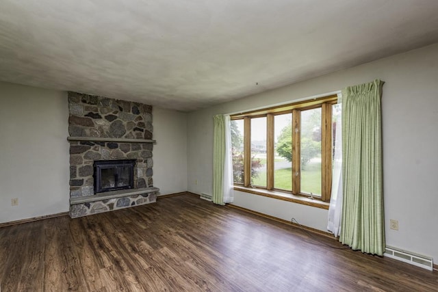 301 Garnett Ave, Winthrop Harbor, IL 60096 - unfurnished living room featuring wood finished floors, baseboards, and a fireplace