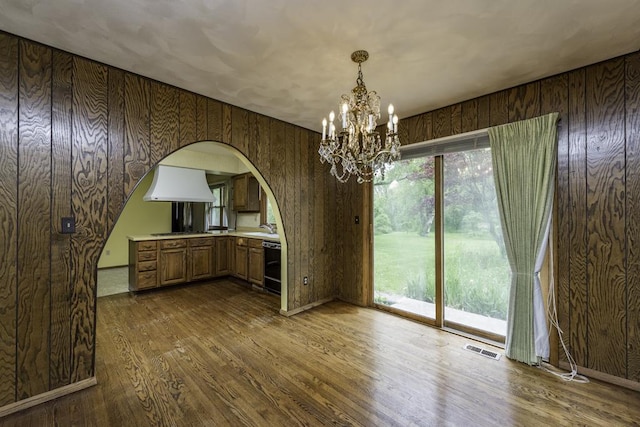 301 Garnett Ave, Winthrop Harbor, IL 60096 - unfurnished dining area featuring arched walkways, a chandelier, dark wood-type flooring, a sink, and plenty of natural light