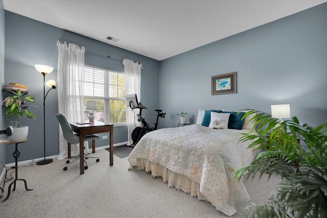 bedroom featuring baseboards, visible vents, and light carpet