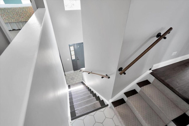 staircase featuring baseboards