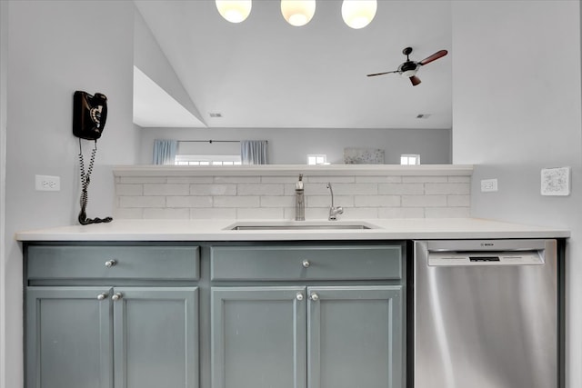 kitchen featuring a sink, dishwasher, light countertops, a ceiling fan, and tasteful backsplash