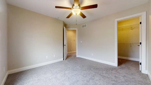 1406 Myrtle Beach Ave, Champaign, IL 61822 - unfurnished bedroom featuring carpet, a walk in closet, a closet, and a ceiling fan