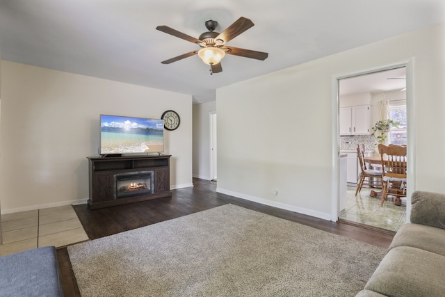 11341 S Nagle Ave, Worth, IL 60482 - living area with ceiling fan, wood finished floors, a lit fireplace, and baseboards