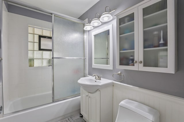 11341 S Nagle Ave, Worth, IL 60482 - full bath featuring toilet, vanity, bath / shower combo with glass door, and a wainscoted wall