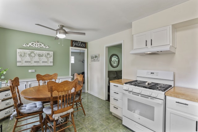 11341 S Nagle Ave, Worth, IL 60482 - kitchen featuring white gas stove, under cabinet range hood, white cabinets, ceiling fan, and tile patterned floors