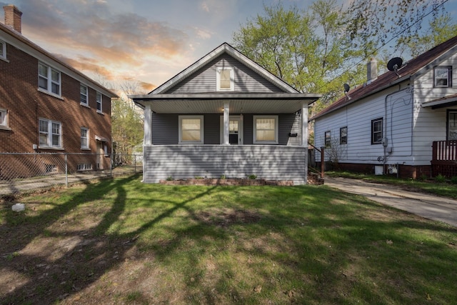 2228 8th St, Rockford, IL 61104 - view of front of house with fence, covered porch, and a yard