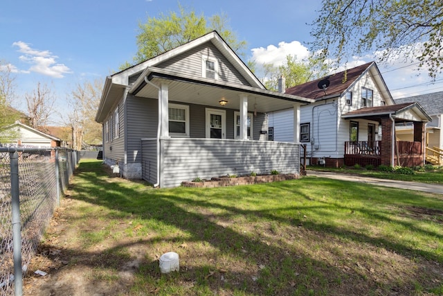 2228 8th St, Rockford, IL 61104 - view of front of house featuring a porch, a front lawn, and fence