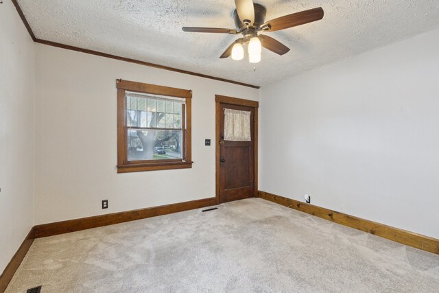 2228 8th St, Rockford, IL 61104 - unfurnished room with carpet floors, a textured ceiling, ceiling fan, and baseboards