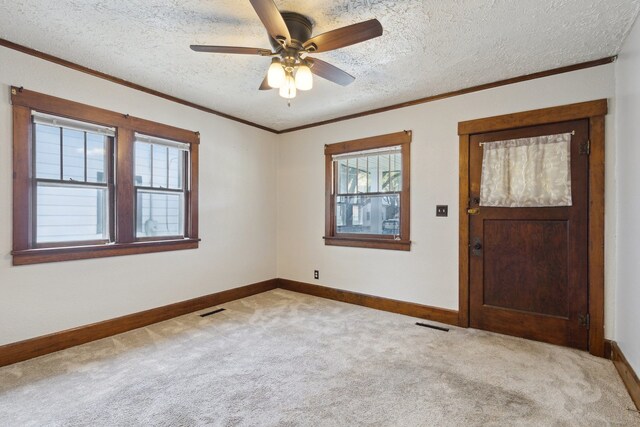 2228 8th St, Rockford, IL 61104 - carpeted empty room featuring baseboards, ornamental molding, a textured ceiling, and visible vents