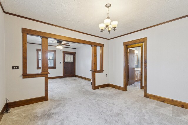 2228 8th St, Rockford, IL 61104 - empty room with an inviting chandelier, ornamental molding, baseboards, light colored carpet, and a textured ceiling
