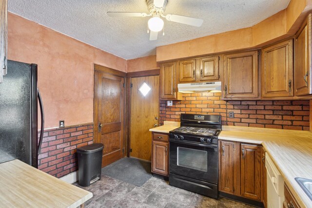 2228 8th St, Rockford, IL 61104 - kitchen with light countertops, black appliances, brown cabinets, and under cabinet range hood