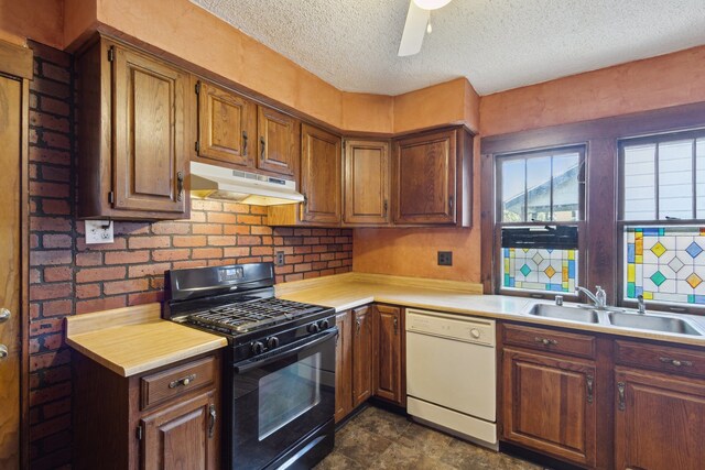 2228 8th St, Rockford, IL 61104 - kitchen featuring white dishwasher, a sink, light countertops, black range with gas cooktop, and under cabinet range hood