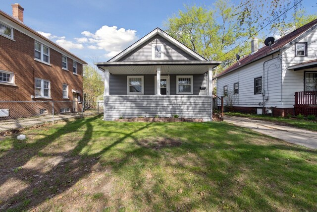 2228 8th St, Rockford, IL 61104 - view of front of home featuring a front lawn, fence, and covered porch