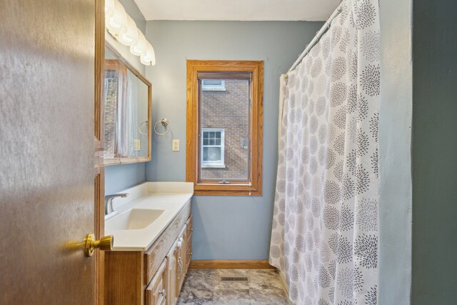 2228 8th St, Rockford, IL 61104 - bathroom featuring baseboards, curtained shower, visible vents, and vanity