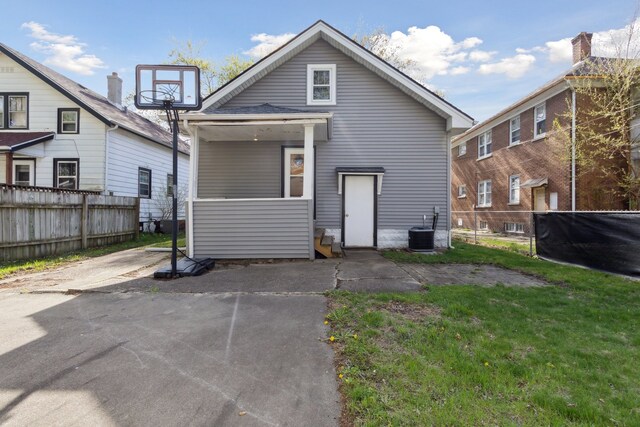 2228 8th St, Rockford, IL 61104 - rear view of property with a yard, fence, and central AC unit