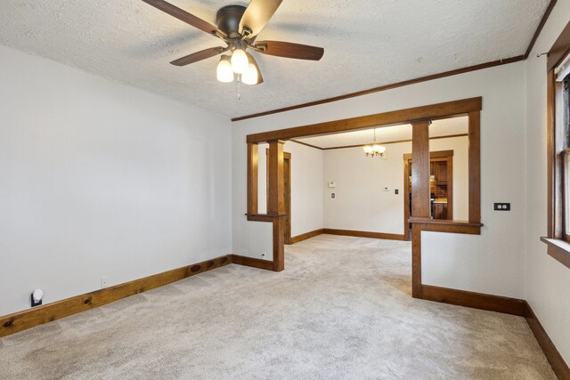 2228 8th St, Rockford, IL 61104 - spare room with crown molding, light colored carpet, a textured ceiling, ceiling fan with notable chandelier, and baseboards