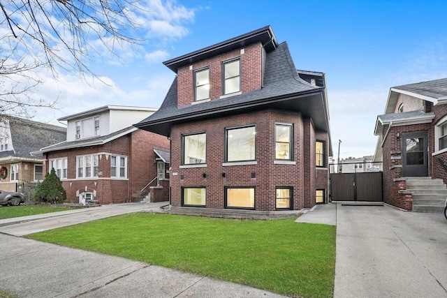 4825 W Oakdale Ave, Chicago, IL 60641 - view of front of property with driveway, a front yard, a gate, brick siding, and roof with shingles