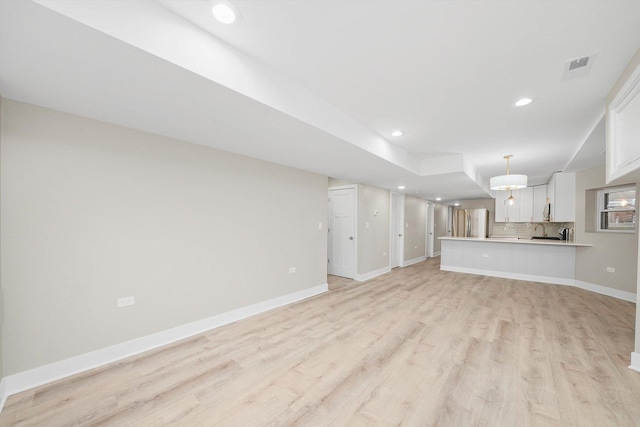 4825 W Oakdale Ave, Chicago, IL 60641 - unfurnished living room featuring light wood-style floors, recessed lighting, and baseboards