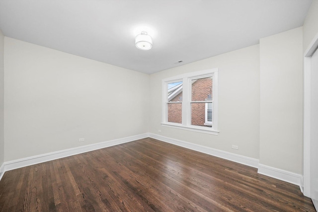 4825 W Oakdale Ave, Chicago, IL 60641 - spare room with dark wood-style flooring and baseboards