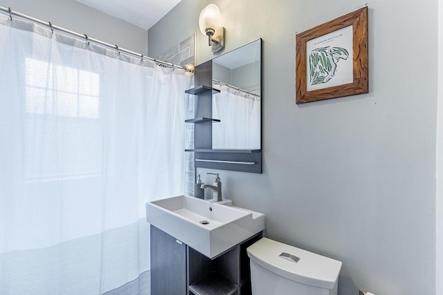 full bath with toilet and a sink