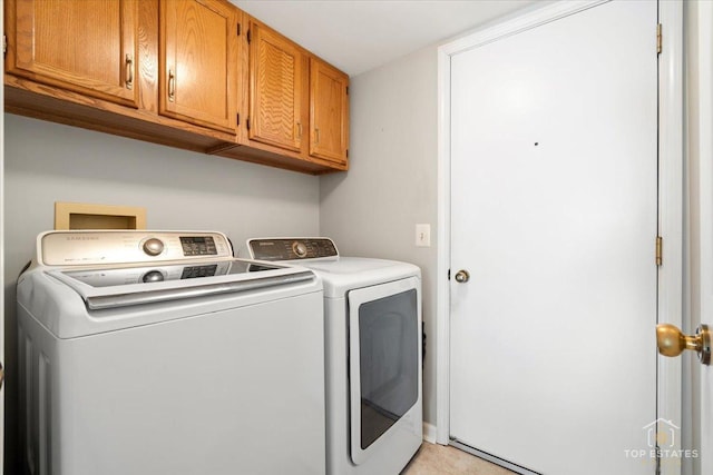 laundry area with cabinet space and separate washer and dryer