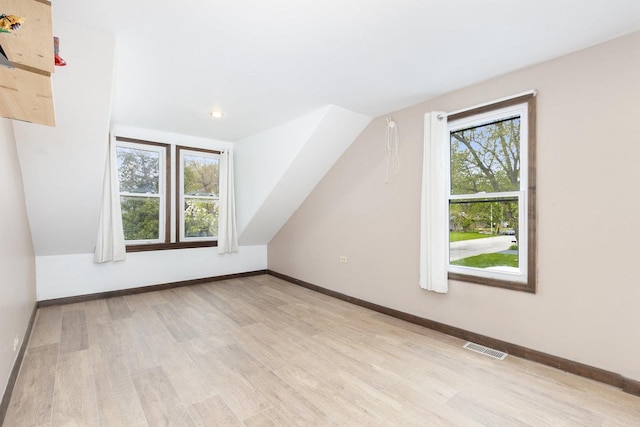 14958 Kildare Ave, Midlothian, IL 60445 - additional living space with light wood-style flooring, healthy amount of natural light, baseboards, and vaulted ceiling