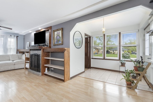 14958 Kildare Ave, Midlothian, IL 60445 - living area with a fireplace, light wood finished floors, a ceiling fan, and a chandelier