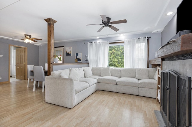 14958 Kildare Ave, Midlothian, IL 60445 - living area featuring ceiling fan, light wood-style floors, a fireplace, decorative columns, and recessed lighting