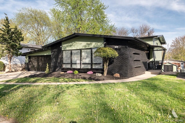251 N Pleasant Dr, Glenwood, IL 60425 - view of home's exterior with brick siding, a storage shed, a garage, an outbuilding, and a lawn