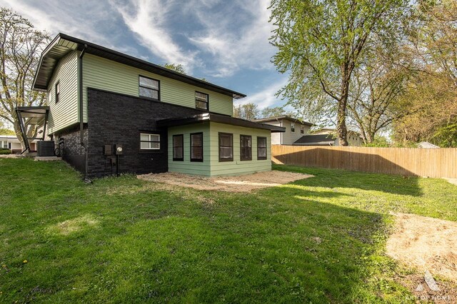 251 N Pleasant Dr, Glenwood, IL 60425 - rear view of house with central air condition unit, fence, a yard, and brick siding