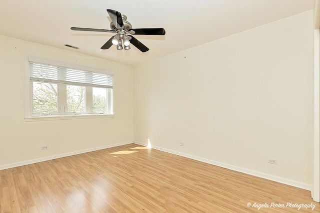 unfurnished room featuring baseboards, ceiling fan, light wood-type flooring, and visible vents