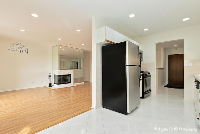 kitchen with modern cabinets, baseboards, white cabinets, stainless steel appliances, and recessed lighting