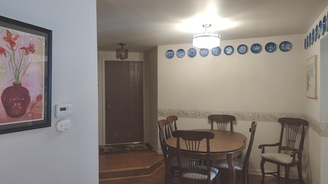 kitchen with under cabinet range hood, a wainscoted wall, a ceiling fan, light wood finished floors, and dishwasher