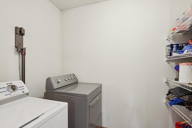 laundry area with independent washer and dryer
