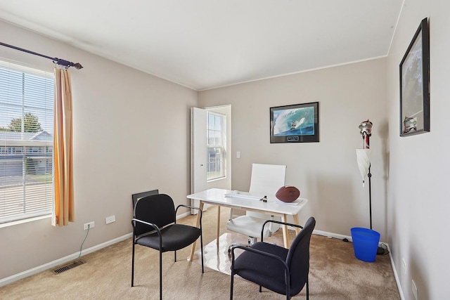 home office featuring light colored carpet, baseboards, and healthy amount of natural light