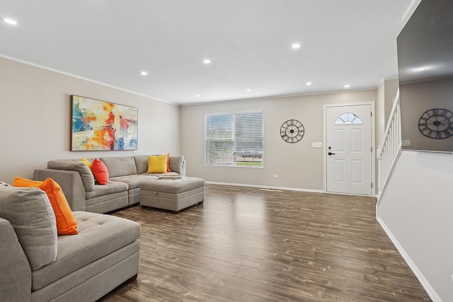 living room with ornamental molding, wood finished floors, baseboards, recessed lighting, and stairway