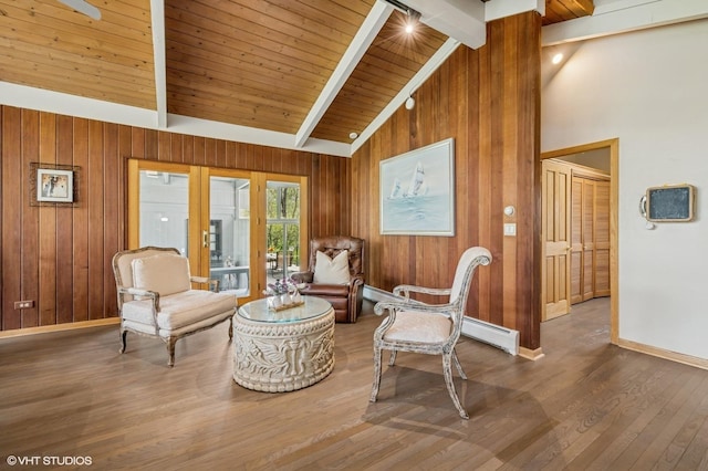 184A River Rd, Lake Barrington, IL 60010 - sitting room featuring beam ceiling, baseboards, wood walls, wood finished floors, and baseboard heating