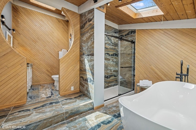 184A River Rd, Lake Barrington, IL 60010 - bathroom featuring wood walls, a skylight, a stall shower, a freestanding bath, and toilet