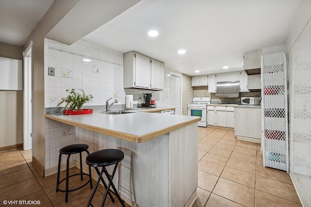 184A River Rd, Lake Barrington, IL 60010 - kitchen featuring white appliances, a sink, light tile patterned floors, a peninsula, and decorative backsplash