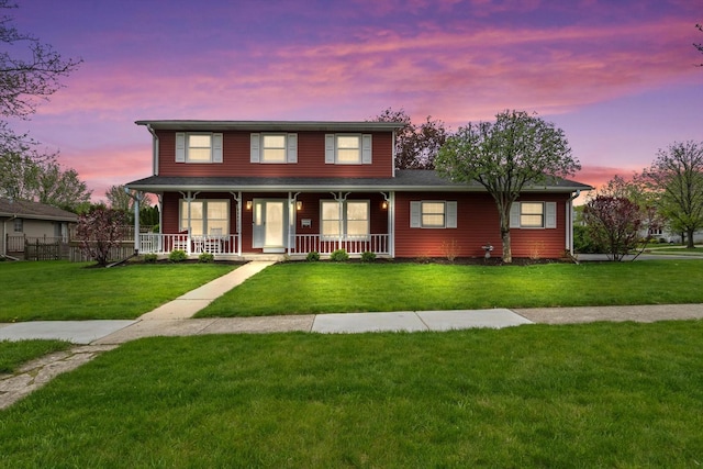 view of front of property featuring covered porch and a front yard