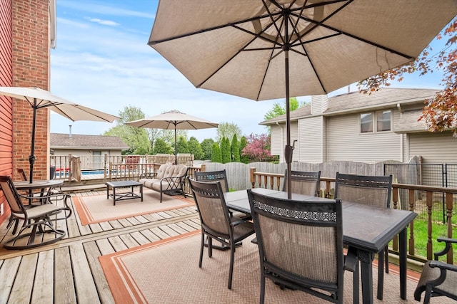 deck with outdoor dining area and a fenced backyard