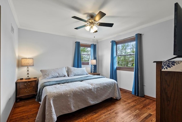 bedroom featuring crown molding, multiple windows, and wood finished floors